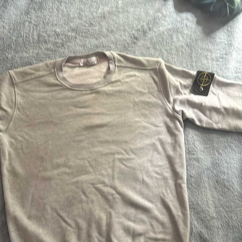 A grey stone island hoodie